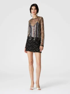Blusa doppiata in tulle con paillettes