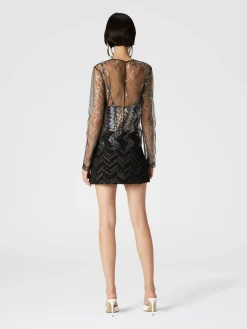 Blusa doppiata in tulle con paillettes