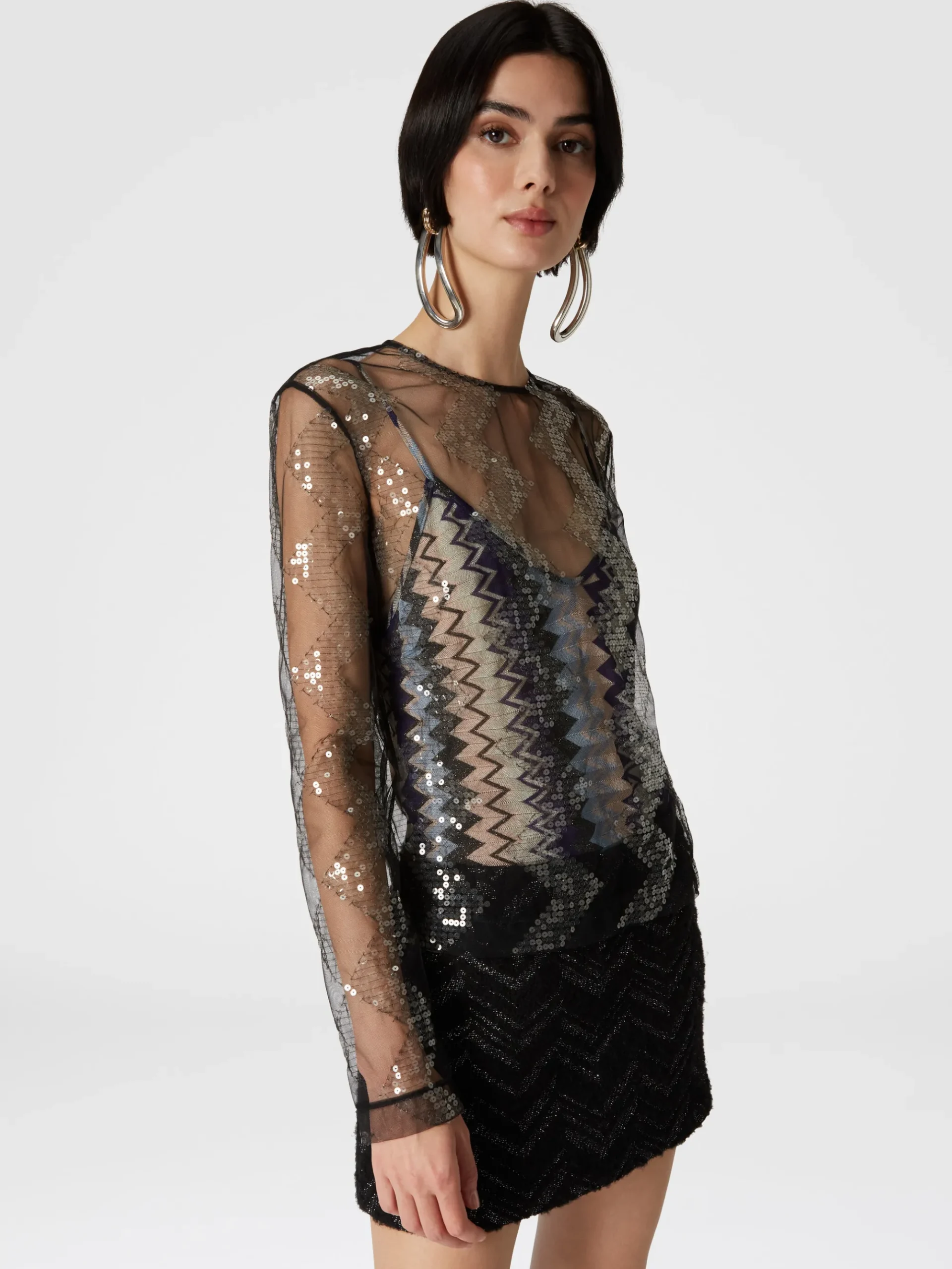 Blusa doppiata in tulle con paillettes